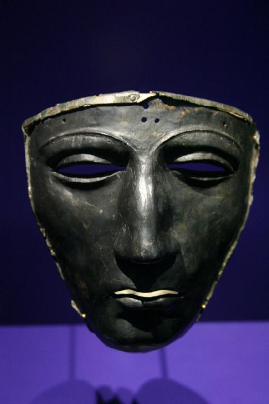 2008-05-20 14:15:30 ** Germany, Kalkriese ** Iron Mask of a Face Helmet

Found in Kalkriese - Oberesch 1990. The Kalkriese mask is currently the oldest known mask of a face helmet. It is made from iron and was covered with sheets of silver. Remains of this are still visible in the corners. Facial features are modeled in great detail, which gives the mask individual character. Face helmets are a pompous part of the equipment for riders and were worn at parades and jousts. It's possible it was also worn in battle.