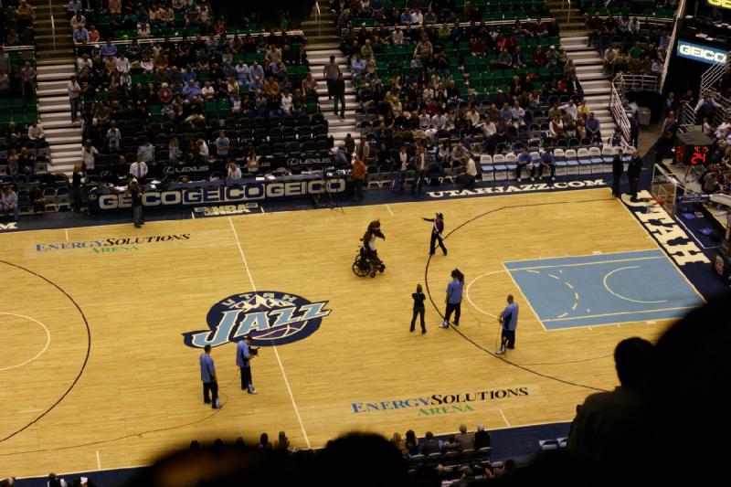 2008-03-03 20:16:24 ** Basketball, Utah Jazz ** The bear brings a wheel chair to pick up the dancer from the court. She declined the offer.
