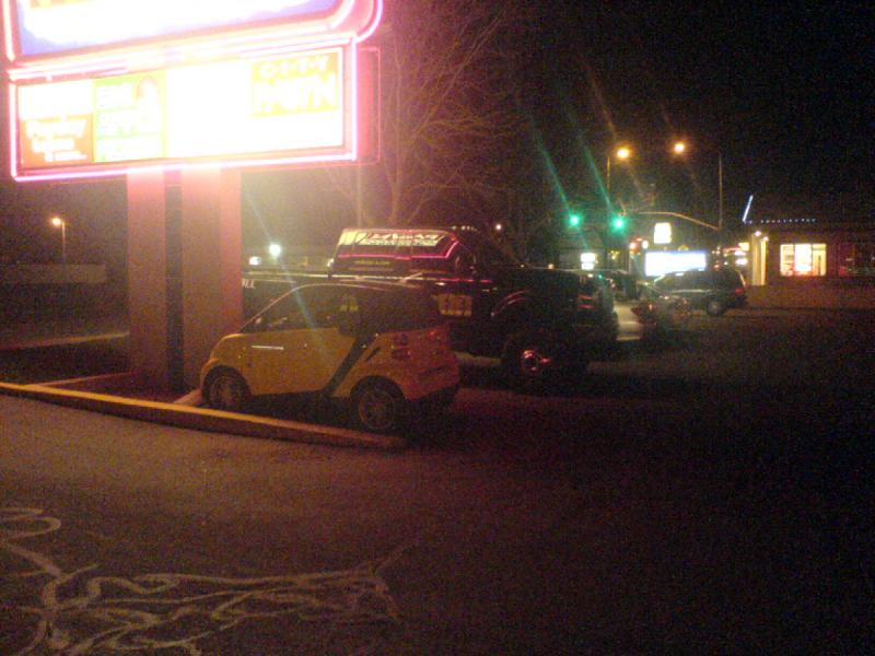 2008-04-05 21:39:00 ** Smart ** My smart on its 'smart parking spot' with a huge pickup truck right next to it. I should really start taking Erica's compact camera with me because the quality of the pictures I take with my cell phone leaves a lot do be desired.